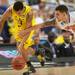Michigan sophomore Trey Burke moves the ball after a steal from Florida junior Scottie Wilbekin during the first half at Cowboys Stadium on Sunday, March 31, 2013. Melanie Maxwell I AnnArbor.com